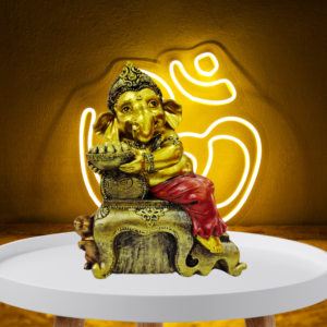 The Global Store - Ganesh ji statue - sitting on sofa and holding one plate of ladoo