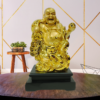 The Global Store - Laughing buddha statue - complete golden wooden base colored black with sack - bg