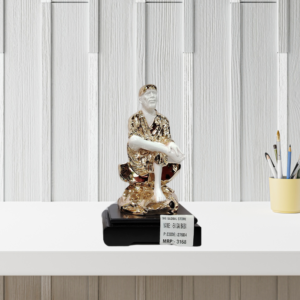 The Global Store - Sai Baba statue - Small rose gold and white with wooden base one leg up on knee - bg
